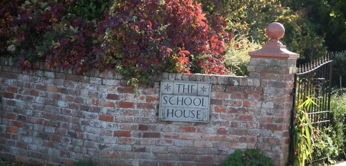 A brick wall with a sign on it
Description automatically generated